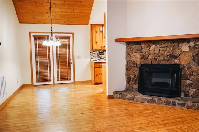 living room with baseboards, lofted ceiling, light wood-type flooring, and a chandelier