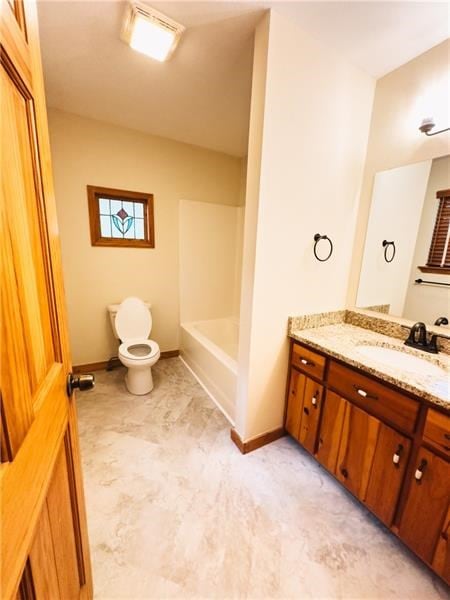 full bathroom with vanity, baseboards, and toilet