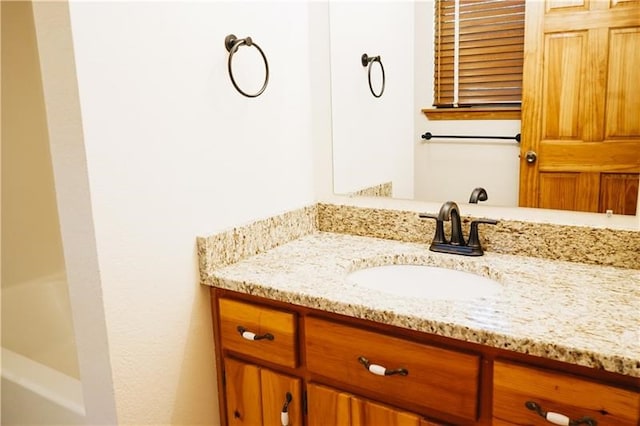 bathroom with vanity and a tub to relax in