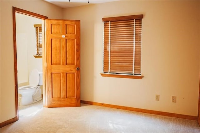 unfurnished room with baseboards and carpet flooring