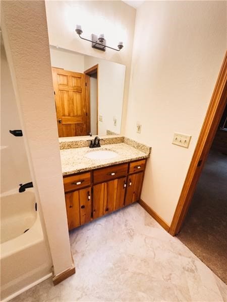 bathroom featuring baseboards and vanity