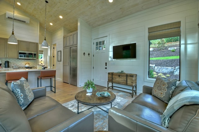 living room with wood walls, light wood-type flooring, high vaulted ceiling, and a wall mounted AC