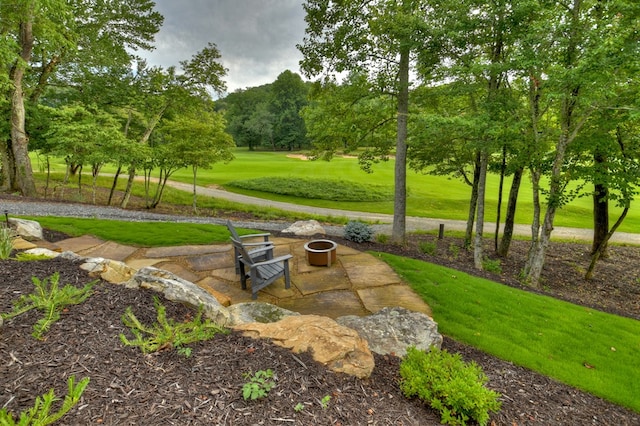 surrounding community with a yard and a patio area