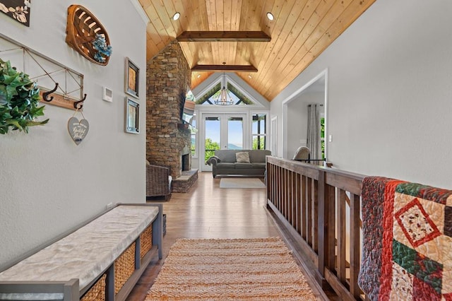 corridor with wooden ceiling, wood finished floors, and french doors