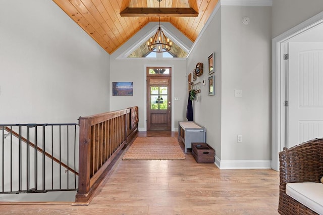 foyer with wooden ceiling, a chandelier, wood finished floors, and baseboards