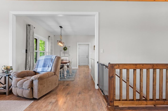 corridor with hardwood / wood-style floors and baseboards