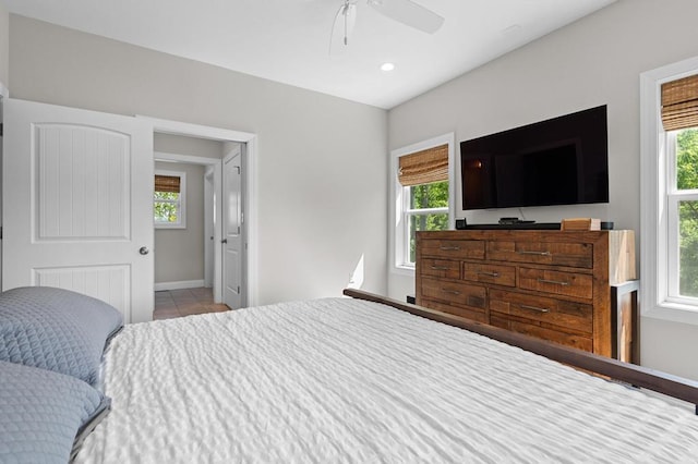 bedroom featuring multiple windows, baseboards, tile patterned flooring, ceiling fan, and recessed lighting