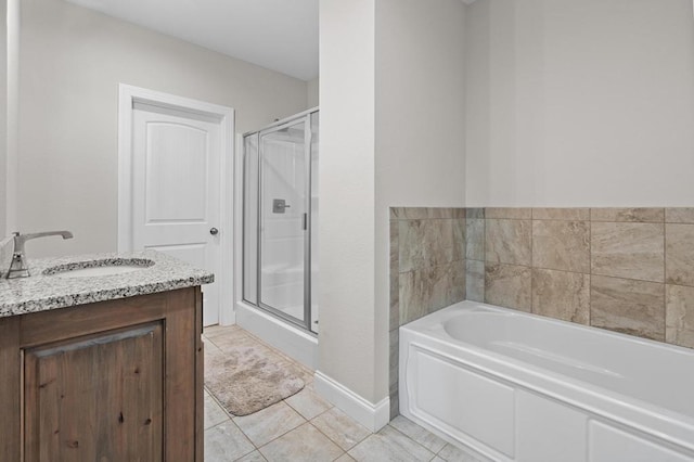 full bathroom with a shower stall, a garden tub, tile patterned floors, baseboards, and vanity