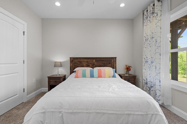carpeted bedroom featuring baseboards and recessed lighting