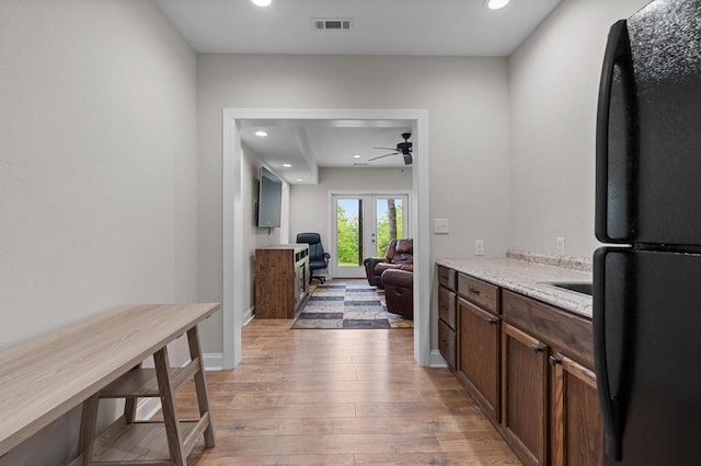 bar featuring freestanding refrigerator, a ceiling fan, light wood-style floors, french doors, and recessed lighting