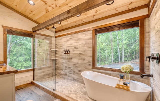 bathroom with a shower stall, a freestanding bath, wood finished floors, visible vents, and wood ceiling