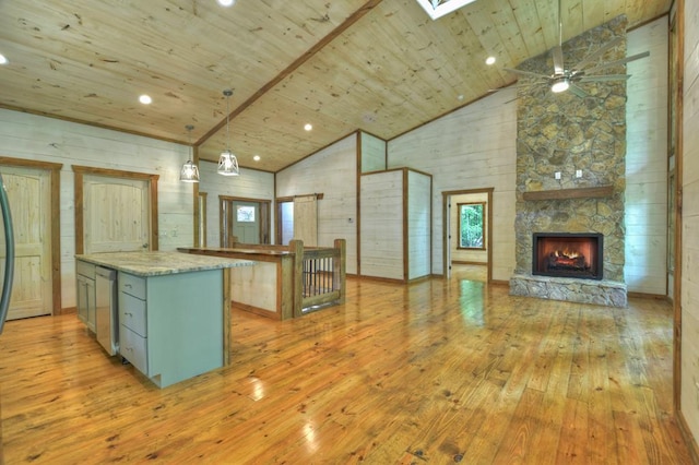 kitchen with light wood-type flooring, open floor plan, ceiling fan, wood ceiling, and high vaulted ceiling