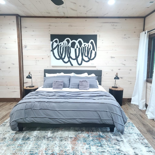 bedroom featuring wood walls and wood finished floors