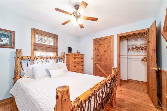 bedroom featuring a ceiling fan, wood finished floors, and baseboards