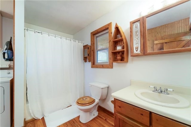 full bathroom with vanity, wood finished floors, washer / clothes dryer, shower / bath combo, and toilet