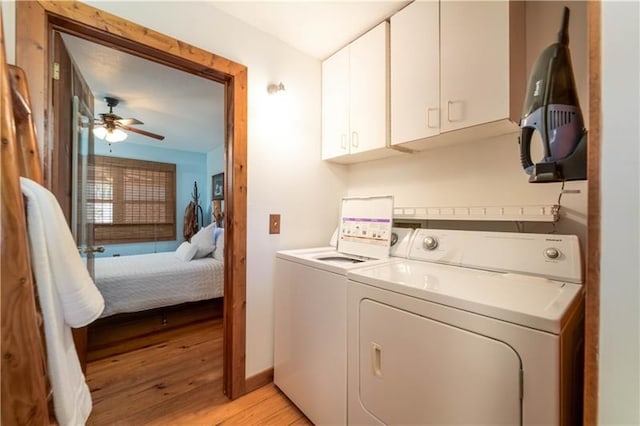 clothes washing area featuring a ceiling fan, baseboards, light wood finished floors, separate washer and dryer, and cabinet space