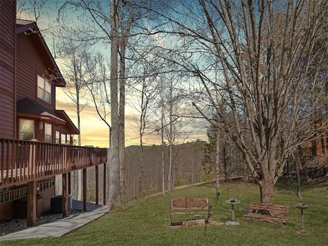 view of yard featuring central AC unit and a wooden deck