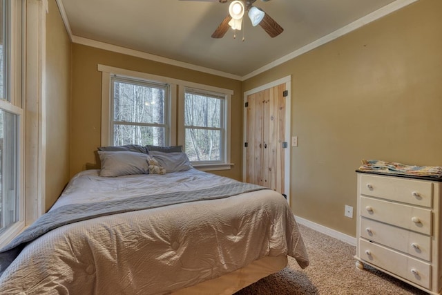 bedroom featuring light colored carpet, a ceiling fan, baseboards, and ornamental molding