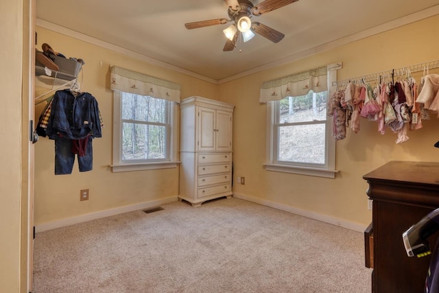 unfurnished bedroom with crown molding, light colored carpet, visible vents, and baseboards