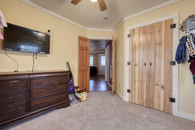 bedroom with a closet, light carpet, baseboards, and ornamental molding