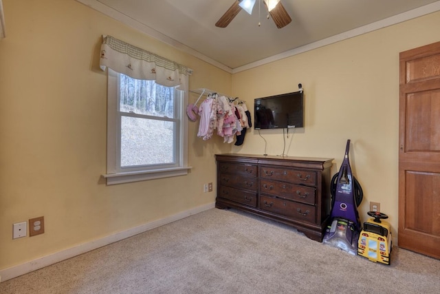 bedroom featuring carpet floors, a ceiling fan, baseboards, and ornamental molding