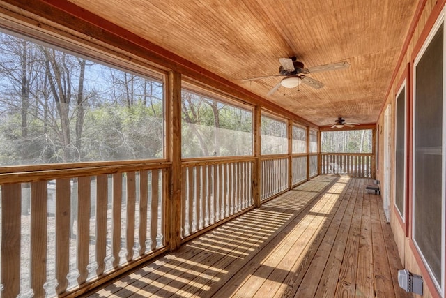 unfurnished sunroom featuring a wealth of natural light and ceiling fan