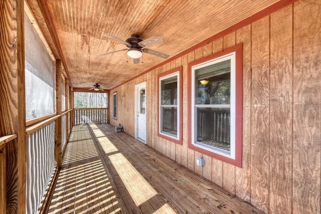 wooden terrace with a ceiling fan