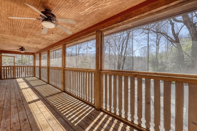 unfurnished sunroom with ceiling fan