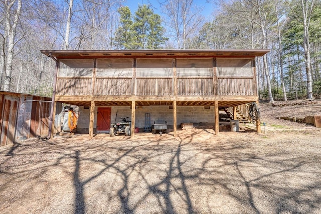 view of outbuilding with stairs and a sunroom