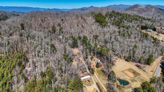 bird's eye view with a mountain view and a wooded view