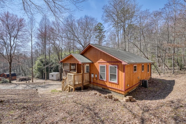 exterior space with cooling unit, a storage unit, and an outdoor structure