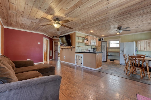 living area featuring baseboards, ornamental molding, wooden ceiling, a ceiling fan, and wood-type flooring