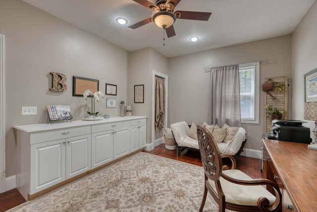 home office with ceiling fan and light hardwood / wood-style flooring