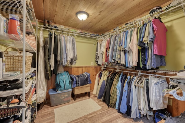 walk in closet with light hardwood / wood-style flooring