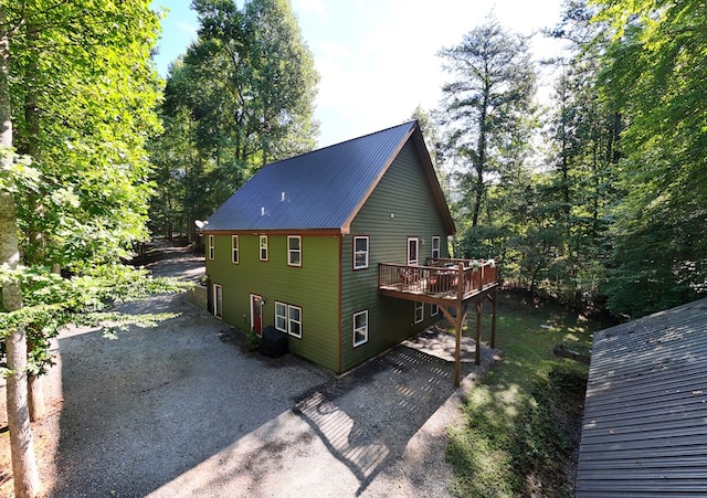 view of property exterior featuring a wooden deck