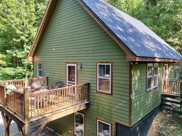 back of property featuring a deck