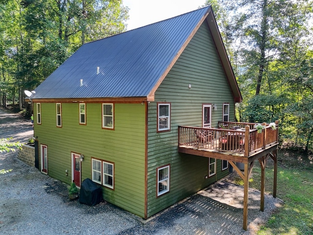 back of house featuring a wooden deck