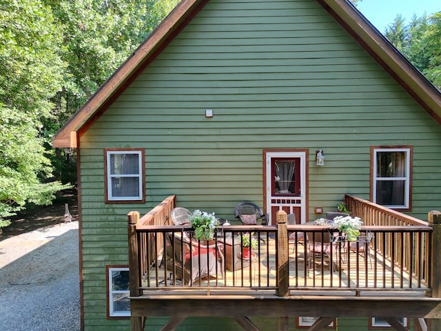 back of house featuring a deck