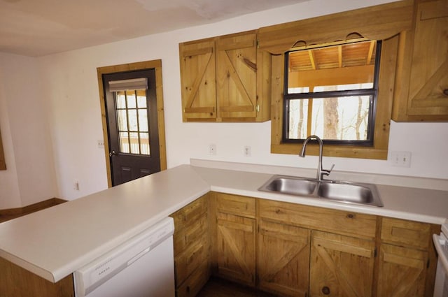 kitchen featuring kitchen peninsula, plenty of natural light, white dishwasher, and sink