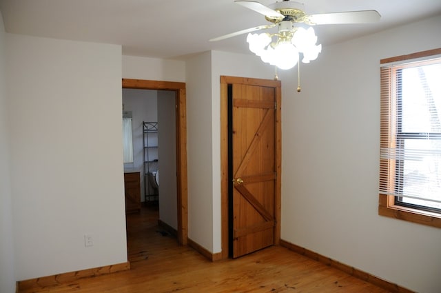 spare room featuring light hardwood / wood-style flooring and ceiling fan