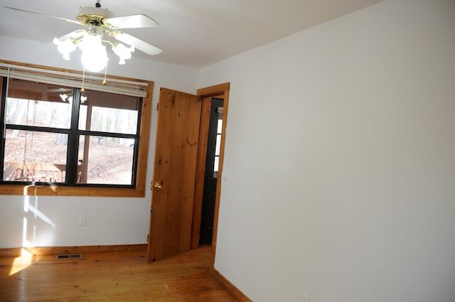 empty room featuring ceiling fan and hardwood / wood-style flooring