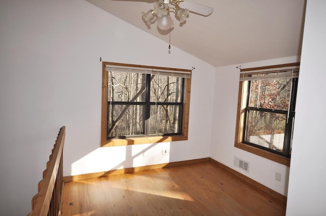 unfurnished dining area with hardwood / wood-style flooring, ceiling fan, and lofted ceiling