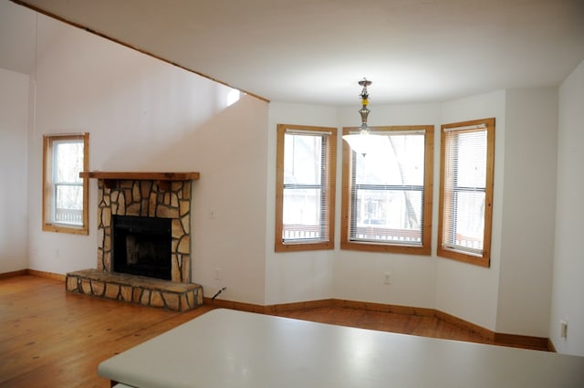 unfurnished living room featuring wood-type flooring and a fireplace