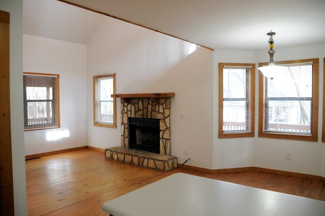 unfurnished living room featuring a fireplace and light hardwood / wood-style floors