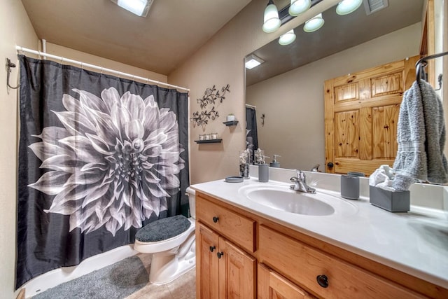 bathroom with toilet and vanity