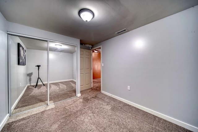 unfurnished bedroom with carpet flooring and a closet