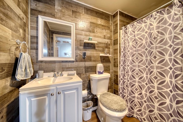 bathroom with tile walls, toilet, wood walls, and vanity