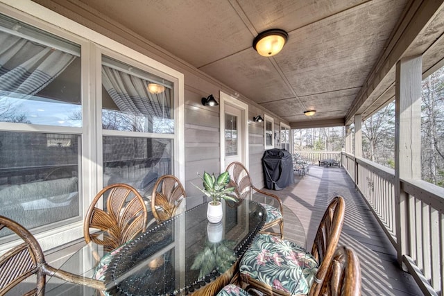 sunroom / solarium featuring a fireplace