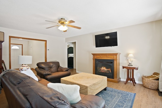 living room featuring light hardwood / wood-style flooring and ceiling fan