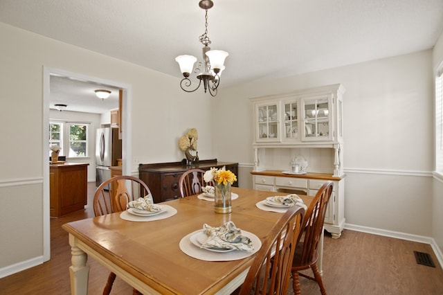 dining area featuring an inviting chandelier and light wood-type flooring